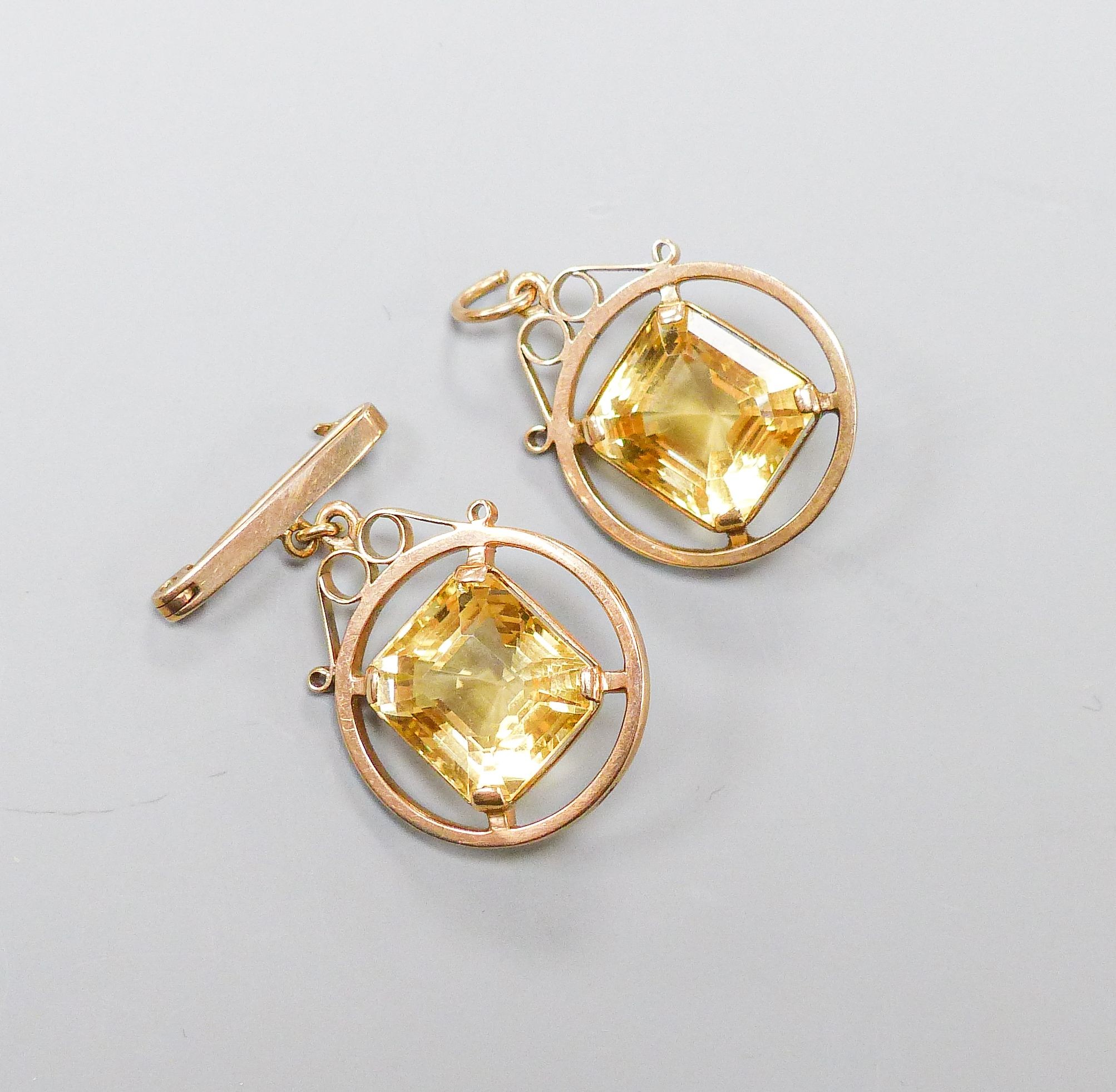 A 9ct mounted step-cut octagonal citrine pendant, 29mm and a matching brooch with suspension pin, gross weight 15.4 grams